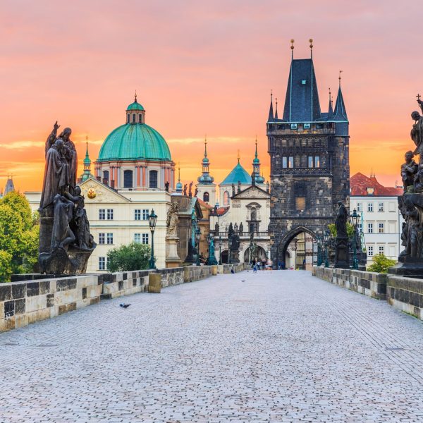 Prague, Czech Republic. Charles Bridge (Karluv Most) and Old Town Tower at sunrise.